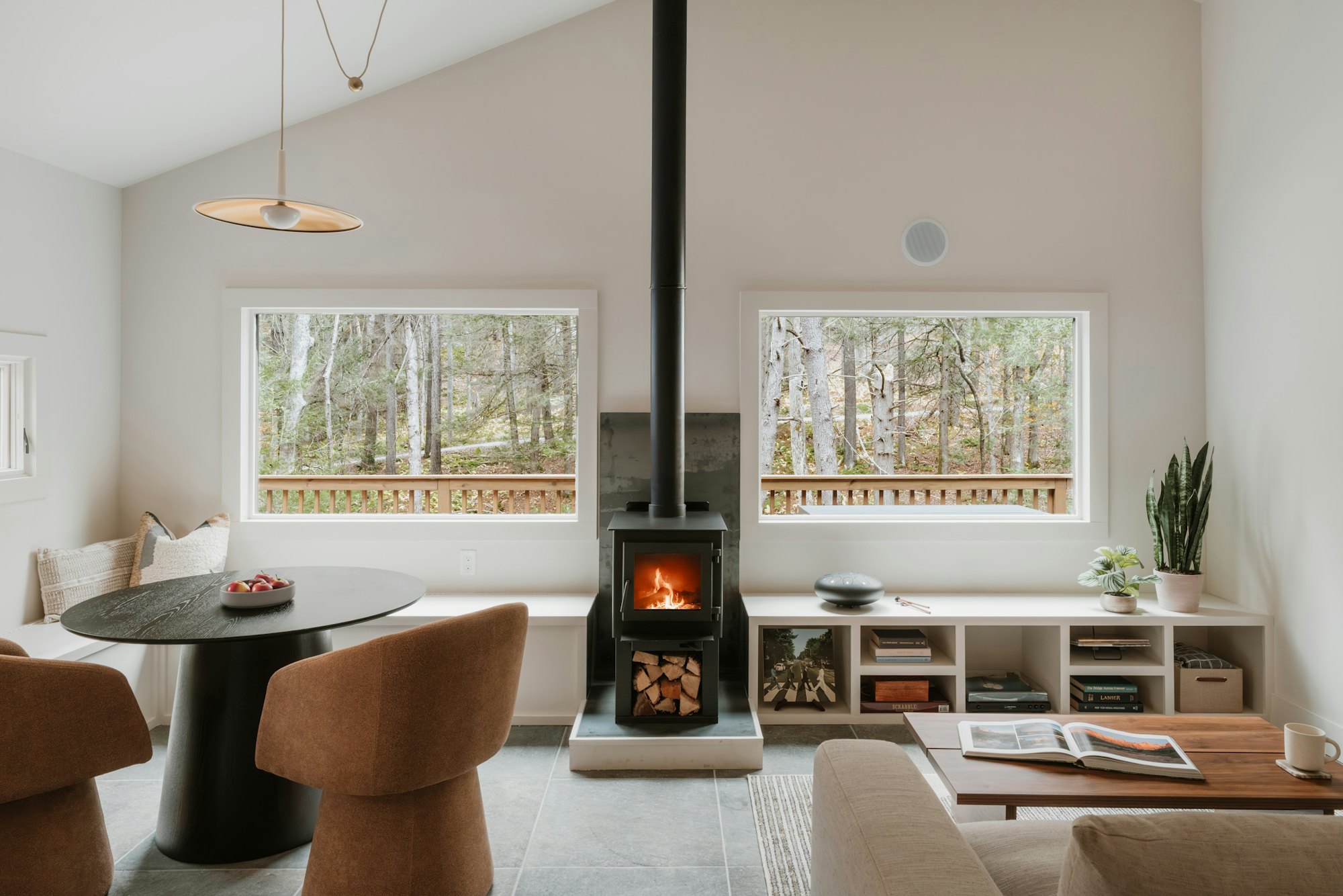 Living room with fireplace and tall windows onto the garden