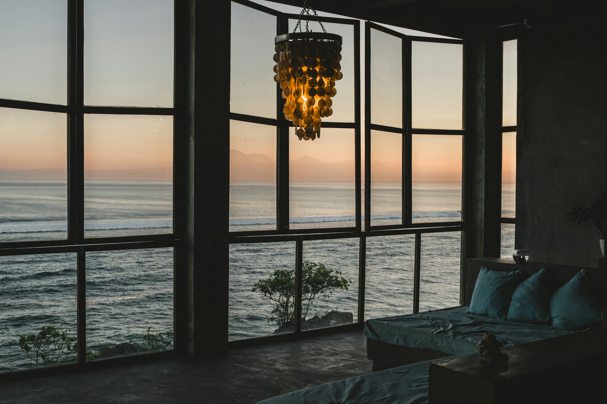Living room at Casa Luzia opening onto the ocean through full-height glazing