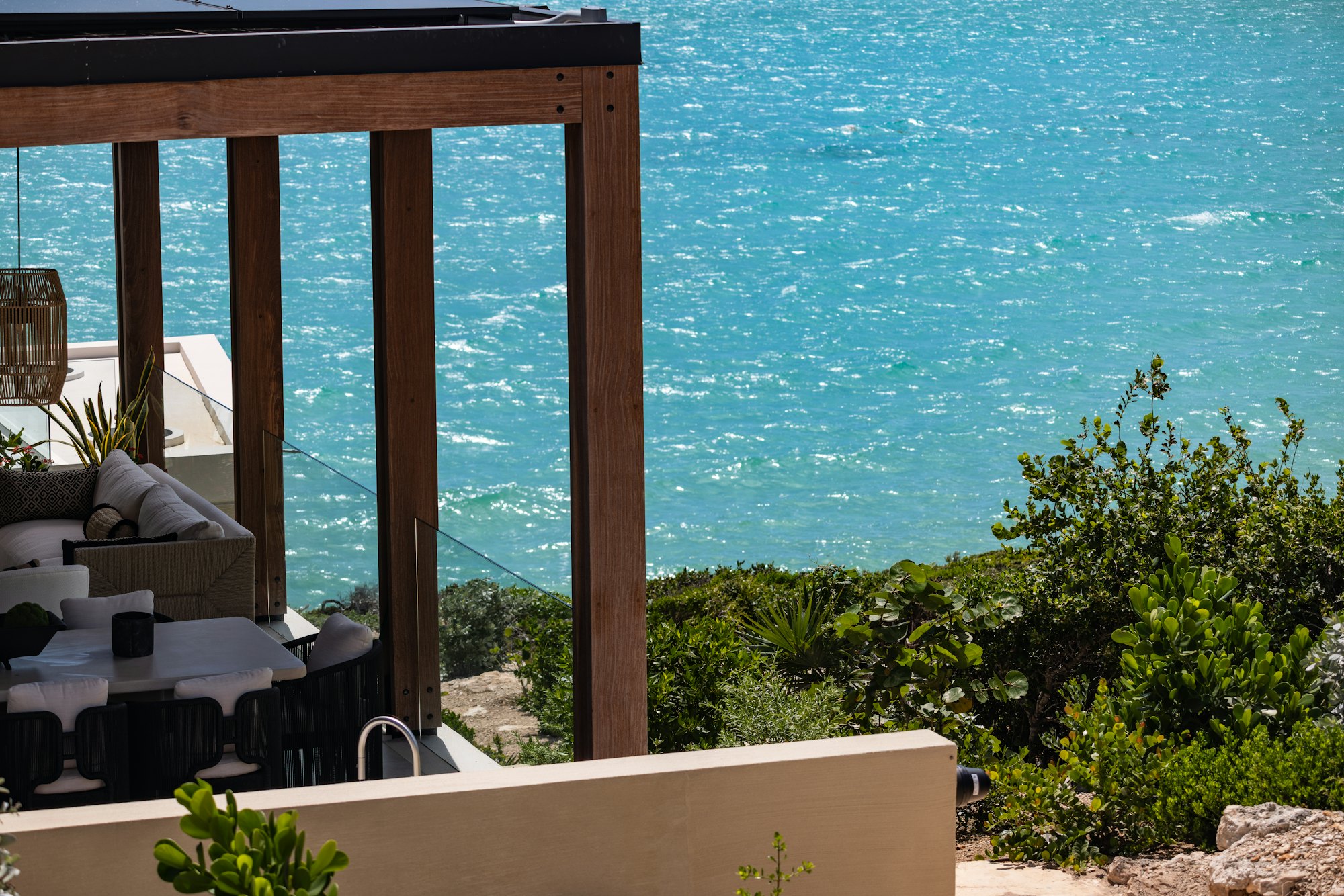 Covered terrace with timber pergola overlooking the water