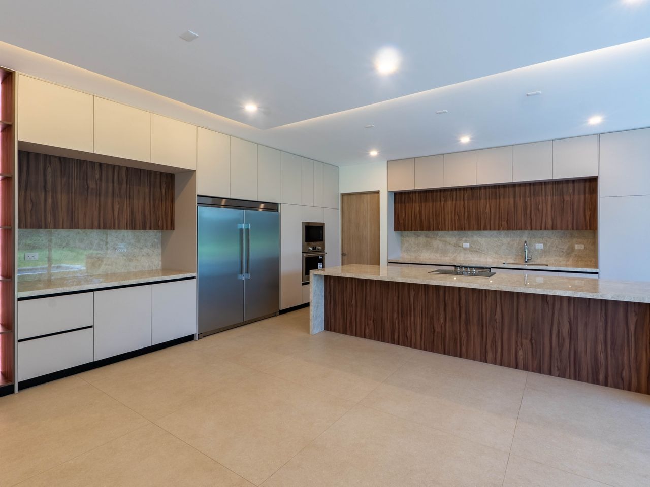 Kitchen with built-in appliances and a full-length island