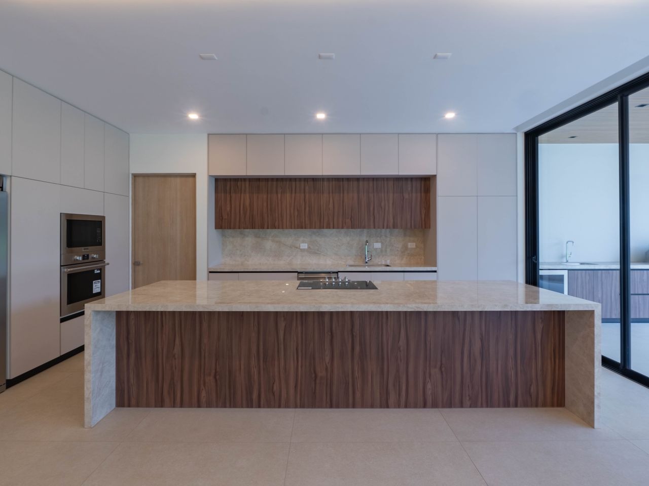The kitchen island, with the oven tower and pantry behind