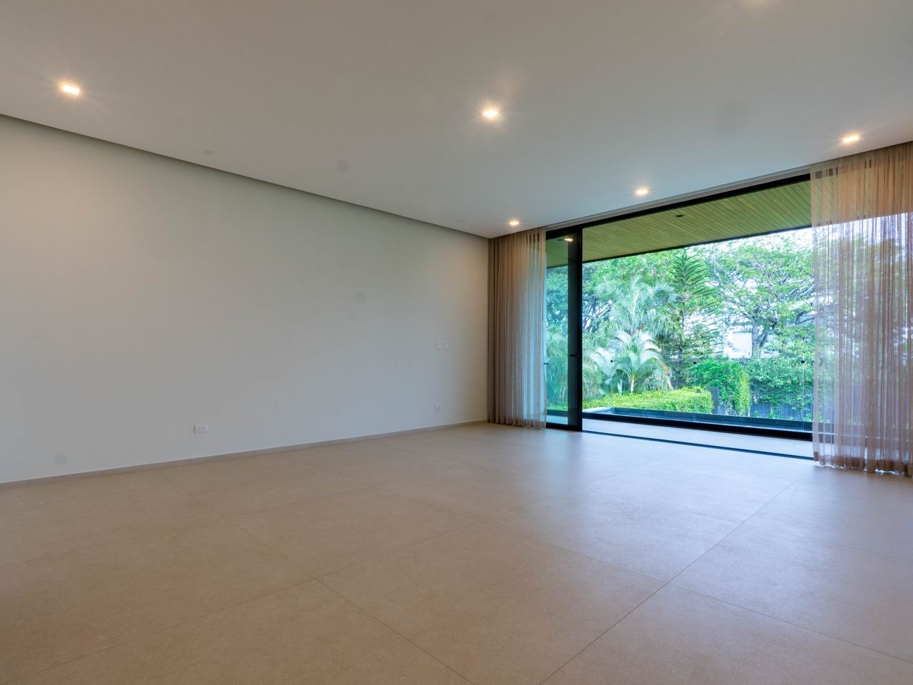 Primary bedroom with full-height glazing onto the garden