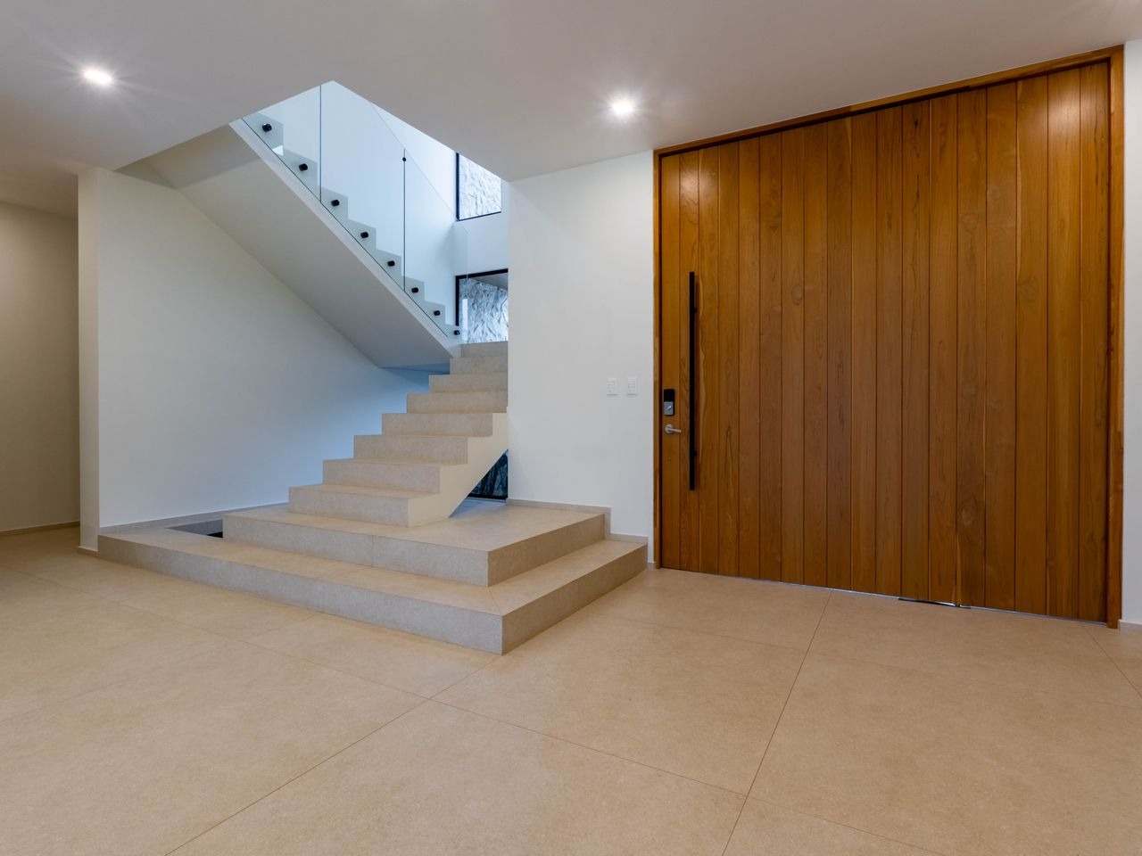 Entrance hall with the staircase and timber front door